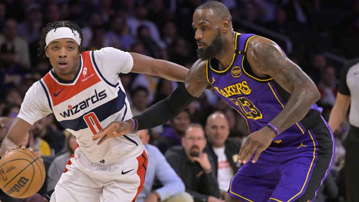 Wizards guard Bilal Coulibaly (0) drives past Los Angeles Lakers forward LeBron James