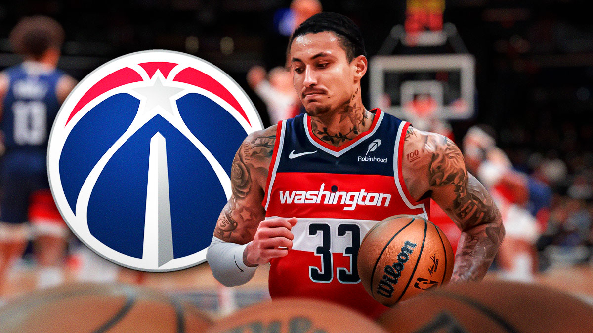 Kyle Kuzma holds basketball and points to himself