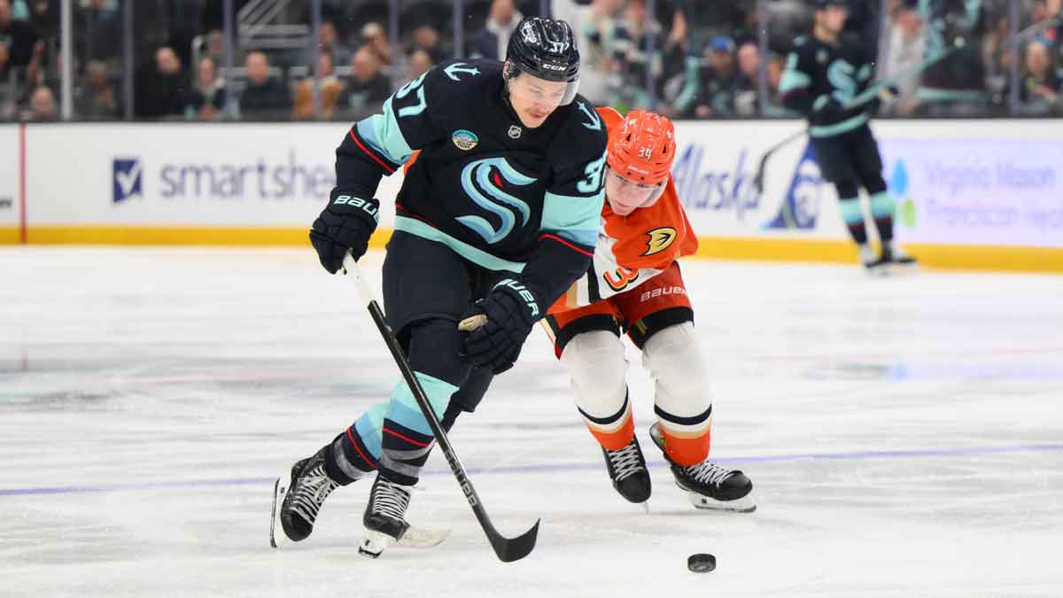 Seattle Kraken center Yanni Gourde (37) advances the puck while defended by Anaheim Ducks defenseman Pavel Mintyukov (34) during the third period at Climate Pledge Arena.