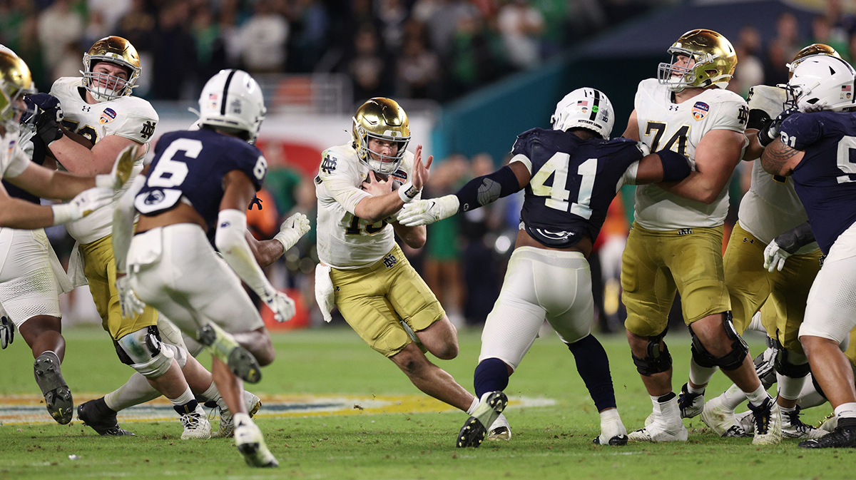 Notre Dame Fighting Irish quarterback Riley Leonard (13) runs the ball in the second half against the Penn State Nittany Lions in the Orange Bowl at Hard Rock Stadium.