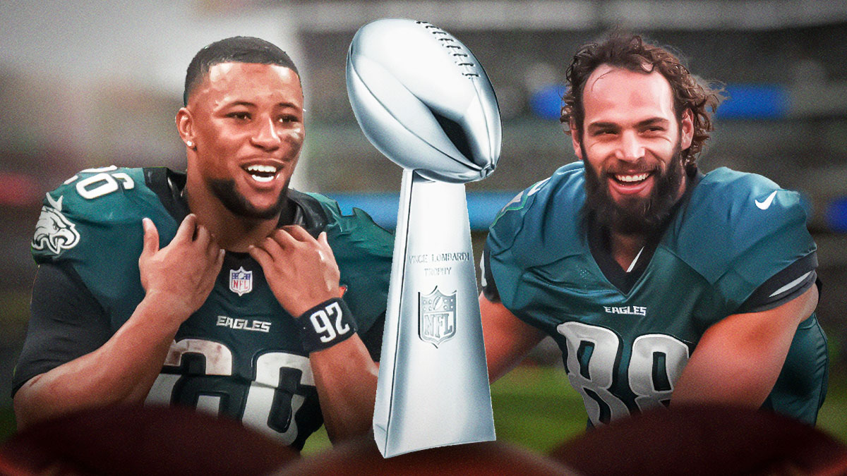 Eagles Dallas Goedert and Saquon Barkley, both smiling/celebrating with the Super Bowl Lombardi Trophy.