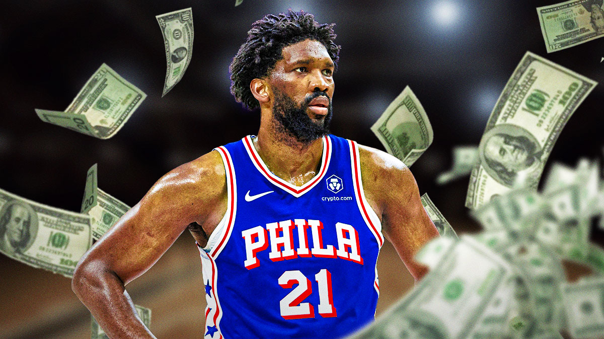 Philadelphia 76ers player Joel Embiid with cash around him
