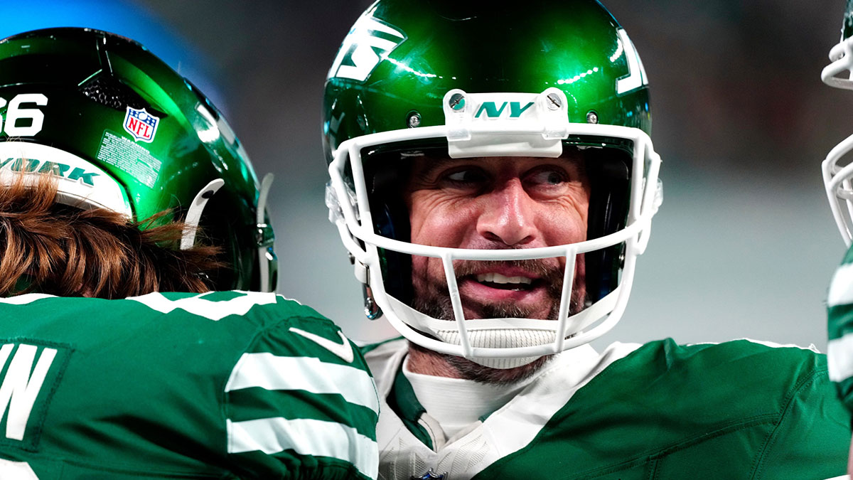 New York Jets quarterback Aaron Rodgers (8) smiles after throwing his fourth touchdown pass of the day, Sunday January 5, 2025, in East Rutherford.