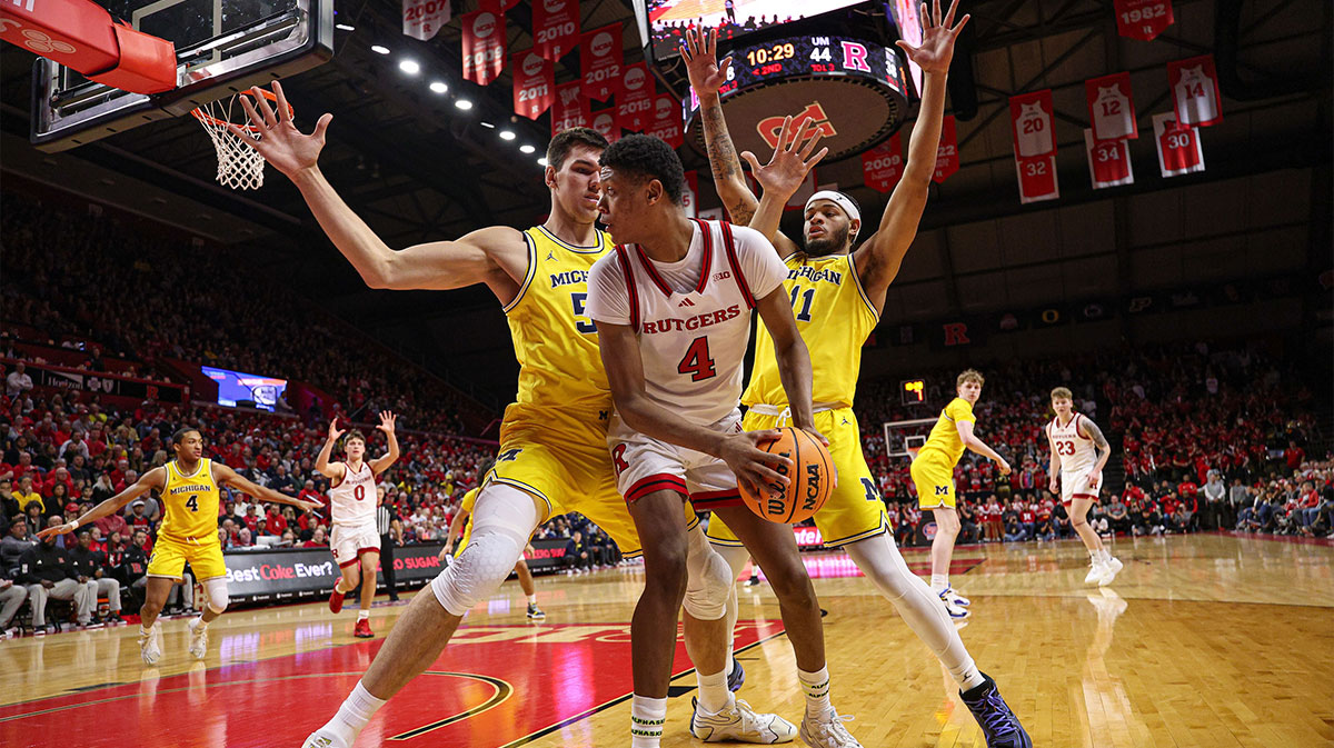 Rutgers Scarlet Knights guard Ace Bailey (4) is guarded by Michigan Wolverines center Vladislav Goldin (50) and guard Roddy Gayle Jr. (11) during the second half at Jersey Mike's Arena.