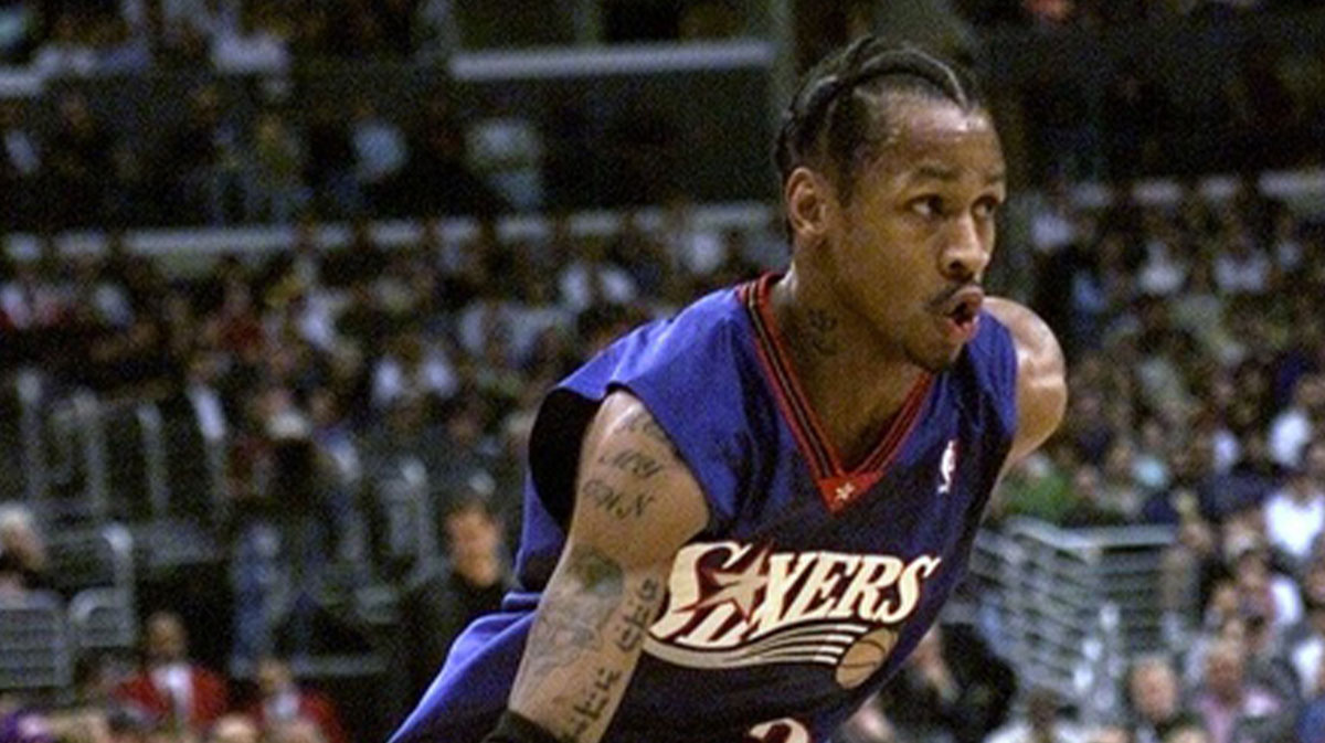 The Allen Iverson Sixers player raises the ball on the field.