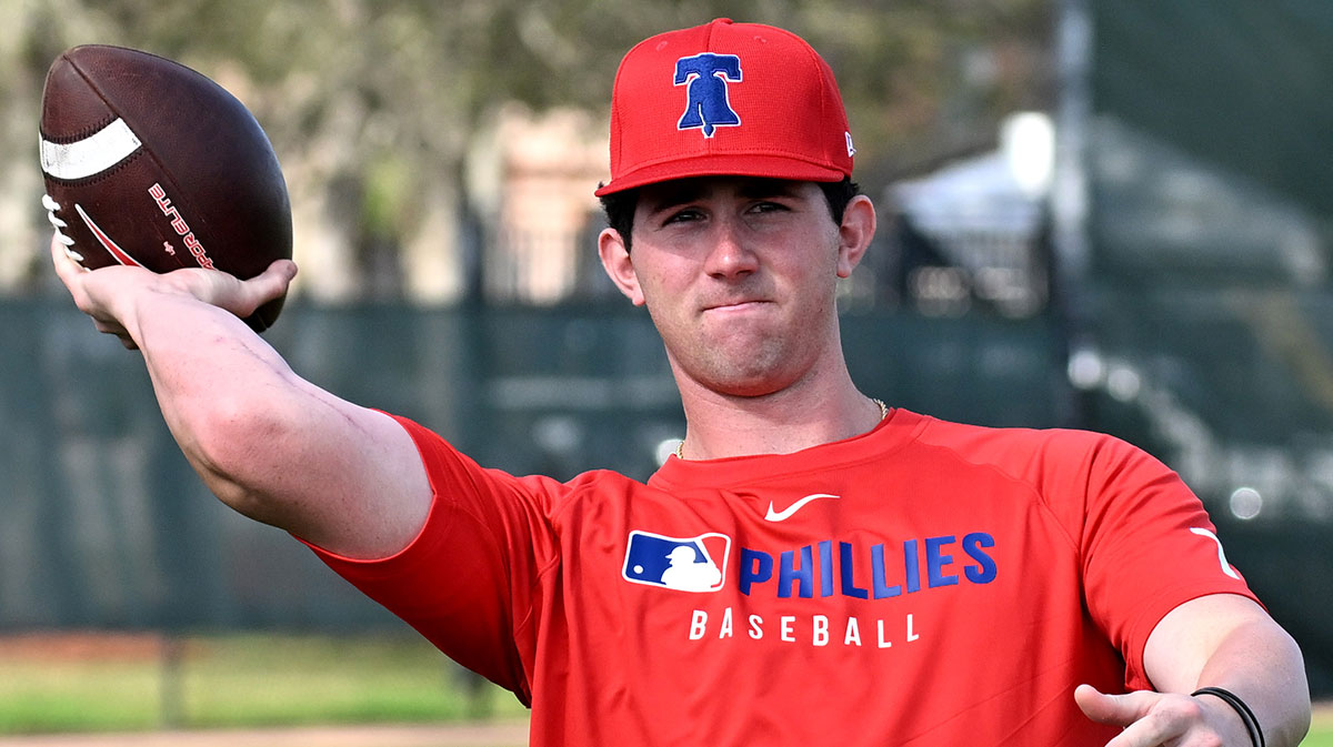 Philadelphia Phillies pitcher Andrew Painter (76) throws a football during a spring training workout at Carpenter Complex.