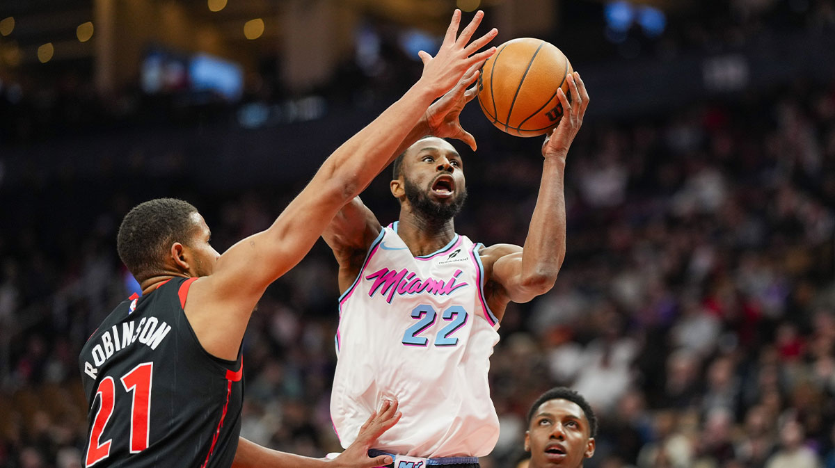 Miami Heat forward Andrew Wiggins (22) drives to the basket against Toronto Raptors center Orlando Robinson (21) during the first half at Scotiabank Arena.