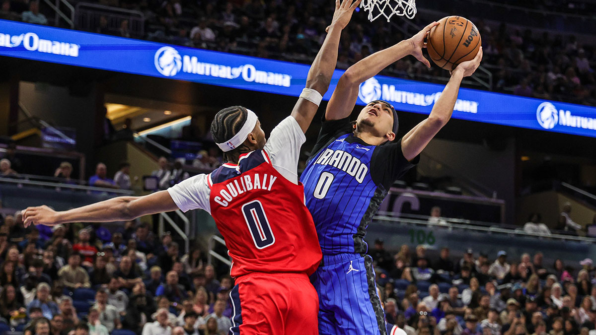 Orlando Magic guard Anthony Black (0) goes to the basket against Washington Wizards guard Bilal Coulibaly (0) during the second half at Kia Center.