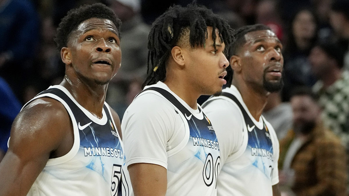 Minnesota Timberwolves guard Anthony Edwards (5) and guard Terrence Shannon Jr. (00) and center Naz Reid (11) walk off the court for a timeout in the first quarter of the game with the Oklahoma City Thunder at Target Center. 