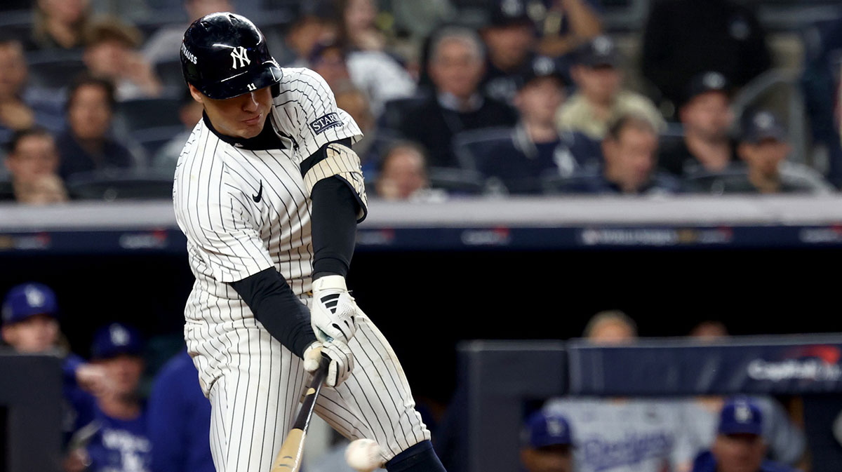 New York Yankees shortstop Anthony Volpe (11) singles during the fifth inning against the Los Angeles Dodgers in game five of the 2024 MLB World Series at Yankee Stadium. 