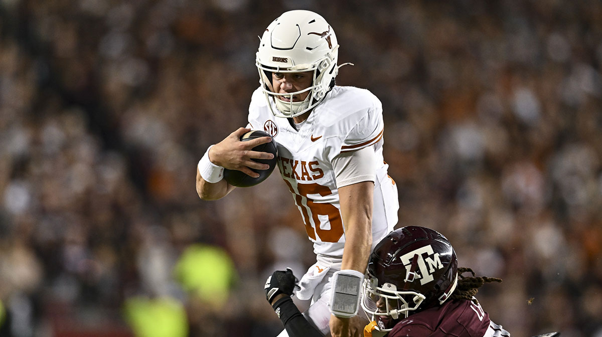 Texas Longhorns quarterback Arch Manning (16) runs the ball as Texas A&M Aggies defensive back Dashawn Fillmore (26) defends during the second quarter at Kyle Field.
