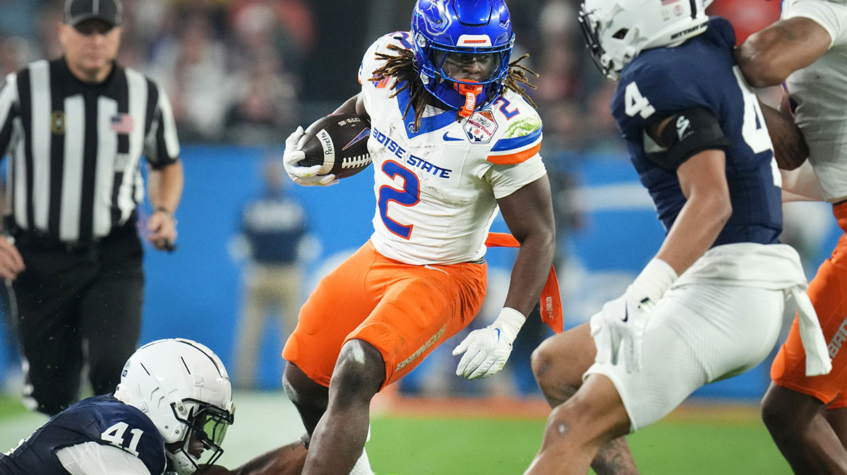 Boise State Broncos running back Ashton Jeanty (2) runs past Penn State Nittany Lions linebacker Kobe King (41) during their Vrbo Fiesta Bowl matchup