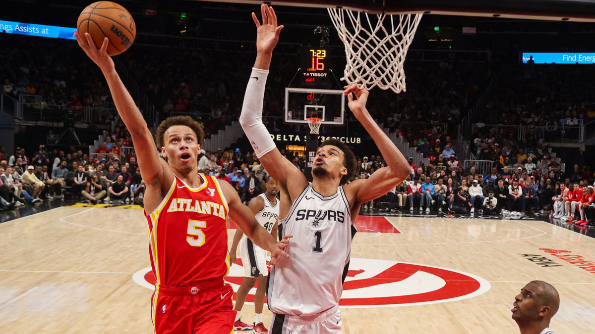 Atlanta Hawks Guard Dison Don Daniels (5) shoots next to San Antonio Spurs Center Victor Vembaniama (1) in the first half at the State Farm Arena.