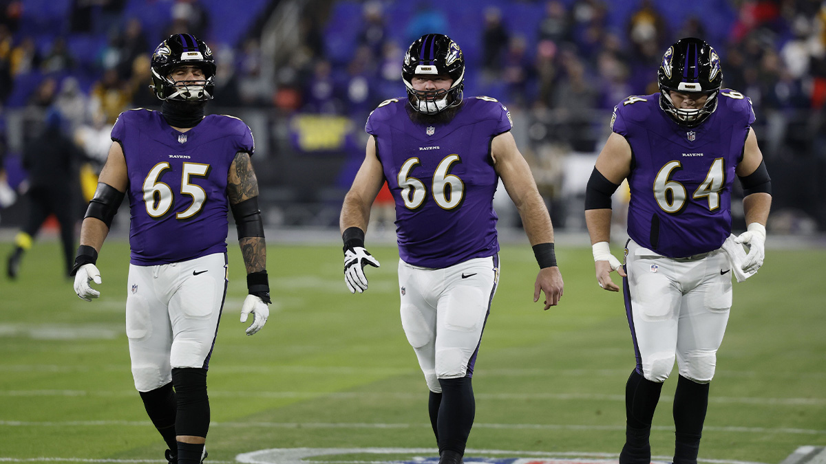 Baltimore Ravens guard Patrick Mekari (65) and guard Ben Cleveland (66) and center Tyler Linderbaum (64) up before an AFC wild card game against the Pittsburgh Steelers at M&T Bank Stadium.