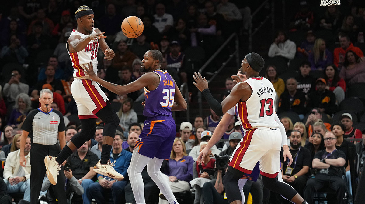 Miami heat Next Jimmy Butler (22) Brings the ball Phoenix Suns Pread Kevin Durant (35) in Miami Heat Center Bam Adebaiio (13) during the first half in the footprint center. 