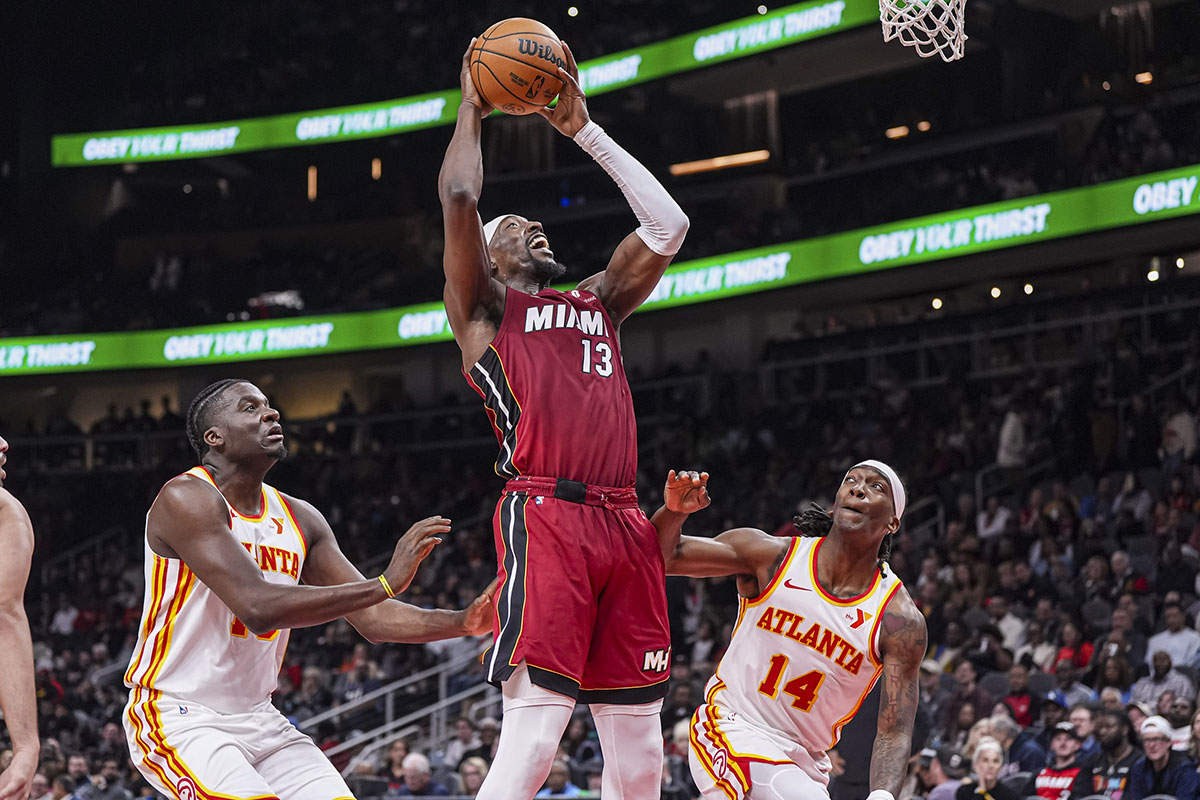 Miami Heat center Bam Adebayo (13) goes to the basket between Atlanta Hawks center Clint Capela (15) and guard Terance Mann (14) during the first half at State Farm Arena.