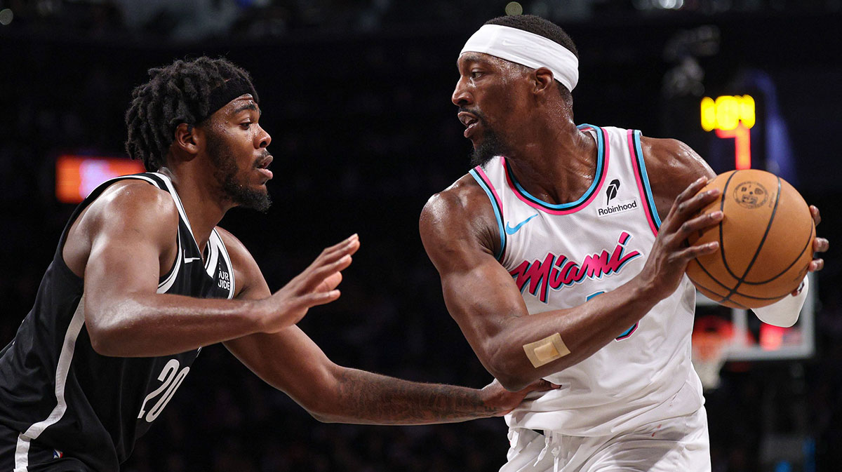 Miami heat center BAM adebaiio (13) protects the ball from Brooklyn Nets Center Dai'ron Sharpe (20) during the second half in the Barclays Center.