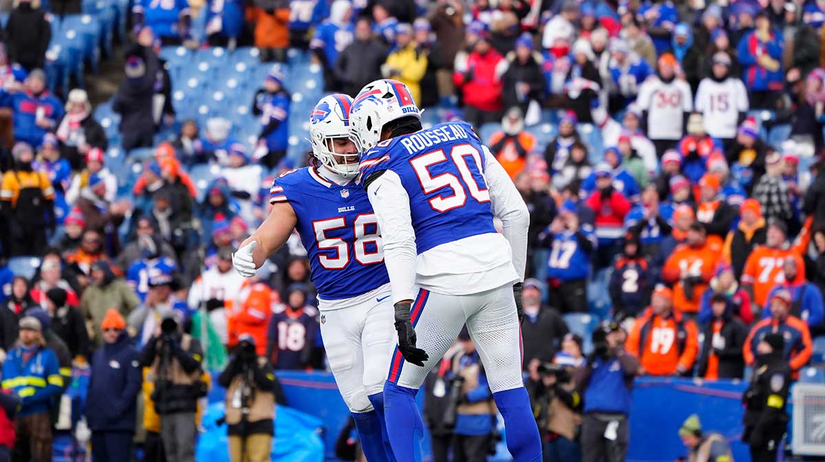 Buffalo Bills linebacker Matt Milano (58) and defensive end Greg Rousseau (50) celebrate a sack during the fourth quarter against the Denver Broncos in an AFC wild card game at Highmark Stadium.