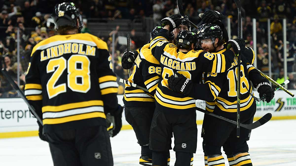 Boston Bruins right wing David Pastrnak (88) left wing Brad Marchand (63) center Pavel Zacha (18) celebrate a goal by center Morgan Geekie (39) during the third period against the Anaheim Ducks at TD Garden.