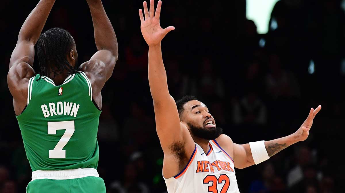 Boston Celtics guard Jaylen Brown (7) shoots the ball over New York Knicks center Karl-Anthony Towns (32) during the first half at TD Garden.