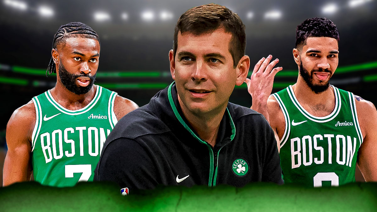 Celtics' Brad Stevens smiling in between Jaylen Brown and Jayson Tatum looking hyped or focused