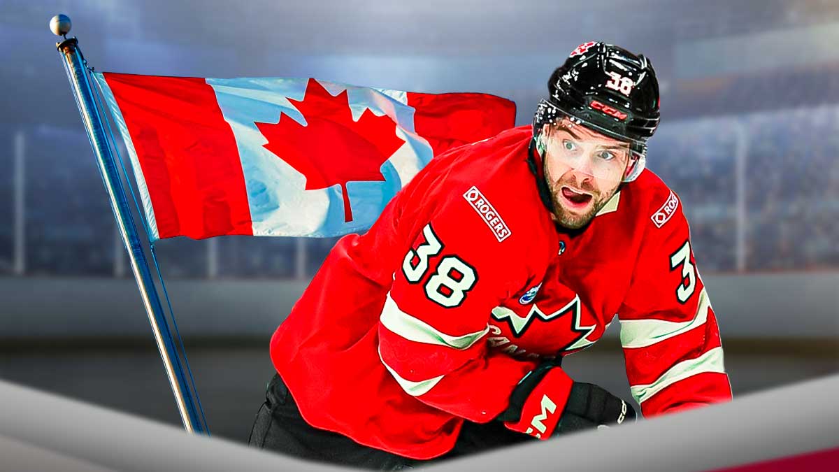 Brandon Hagel with Team Canada. Canadian flag next to him
