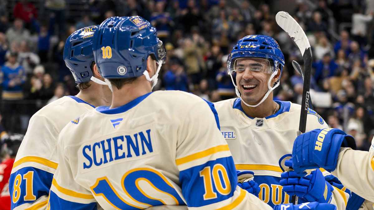 St. Louis Blues right wing Mathieu Joseph (71) celebrates with center Dylan Holloway (81) and center Brayden Schenn (10) after scoring against the Chicago Blackhawks during the second period at Enterprise Center.