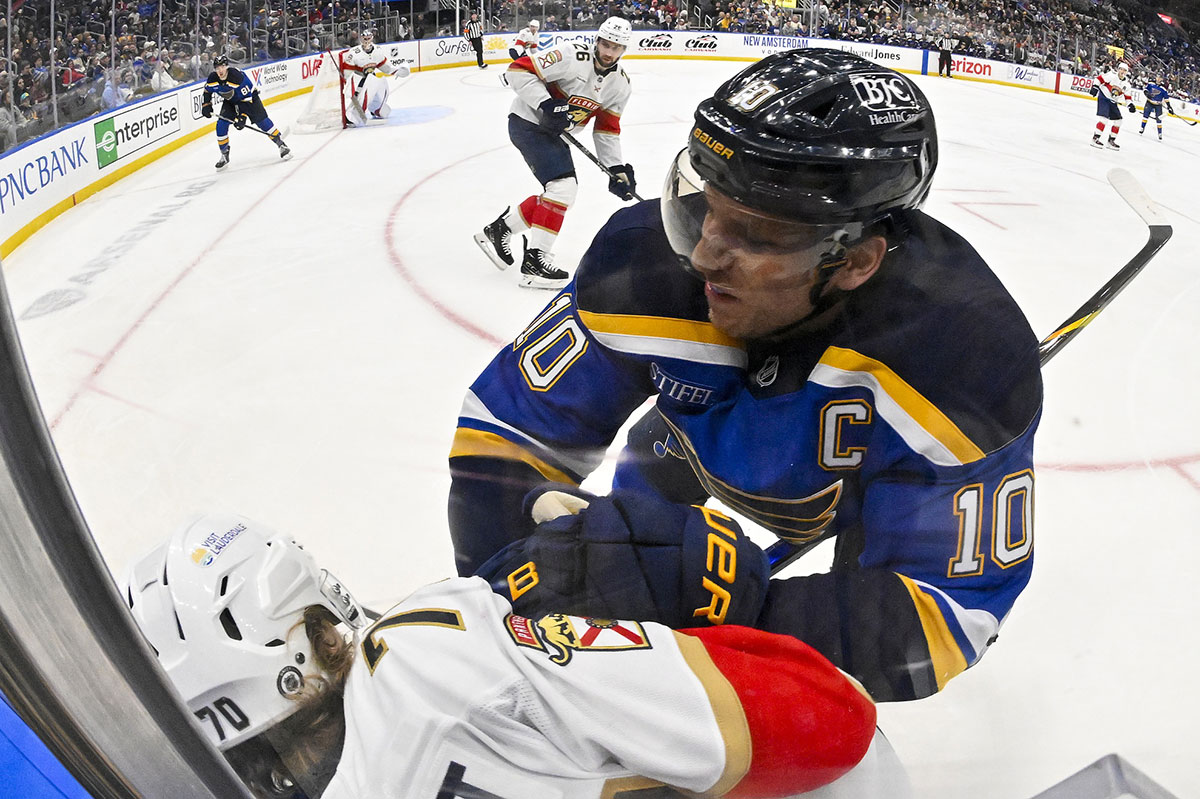 St. Louis Blues center Brayden Schenn (10) checks Florida Panthers center Jesper Boqvist (70) during the second period at Enterprise Center.