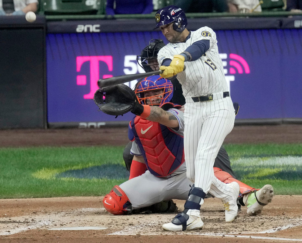 Milwaukee Brewers outfielder Blake Perkins (16) hits a deep fly ball to score second baseman Brice Turang during the fifth inning of their wild-card playoff game against the New York Mets