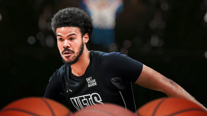 Cameron Johnson in a Nets jersey with Barclays Center in the background.