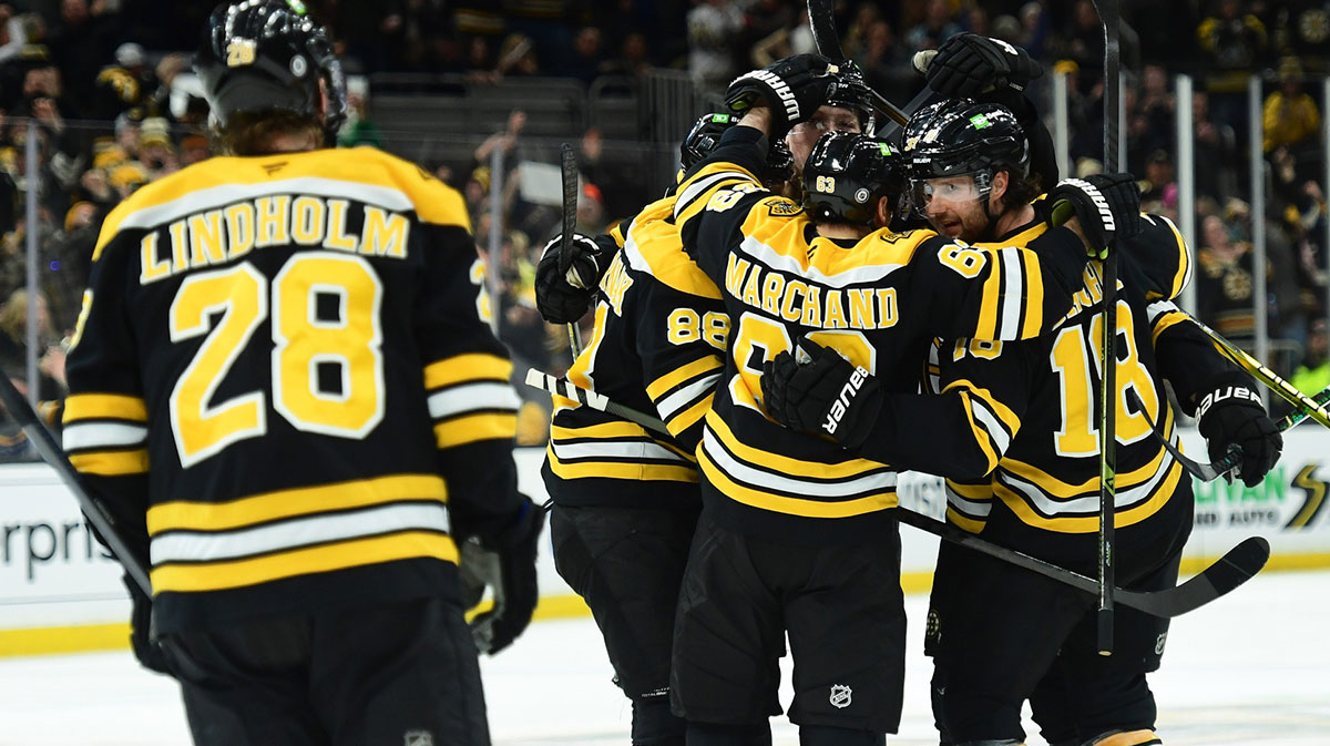Boston Bruins right wing David Pastrnak (88) left wing Brad Marchand (63) center Pavel Zacha (18) celebrate a goal by center Morgan Geekie (39) during the third period against the Anaheim Ducks at TD Garden.