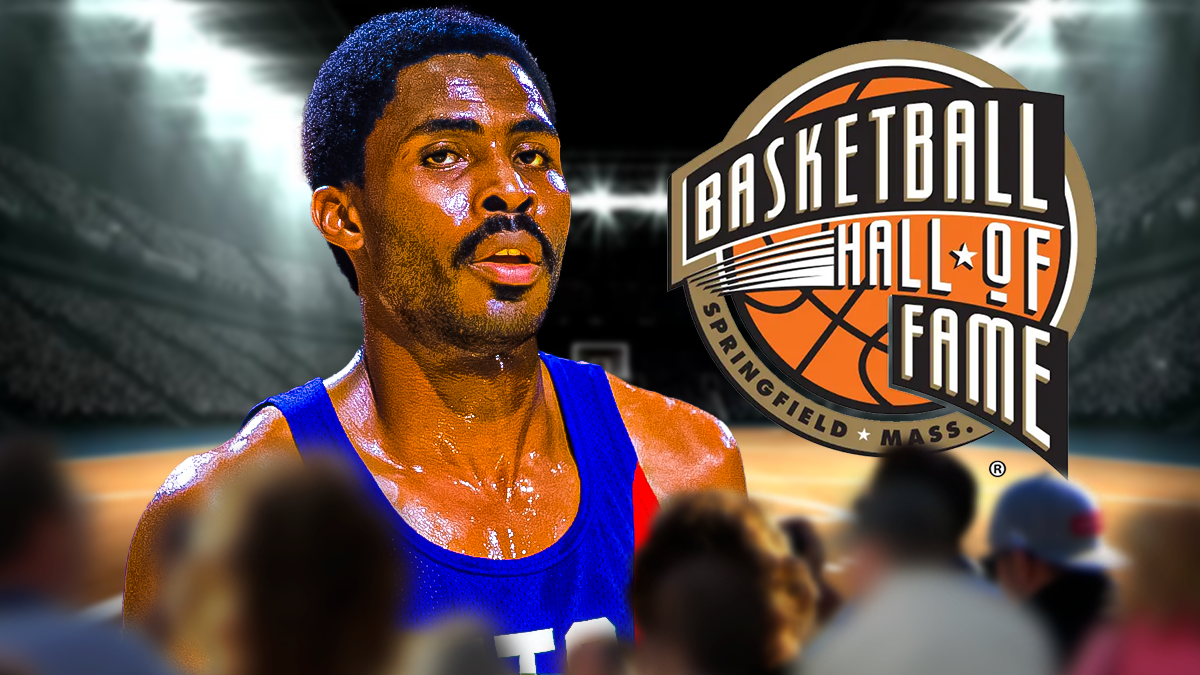 Buck Williams in a Nets uniform with the Hall of Fame logo next to him