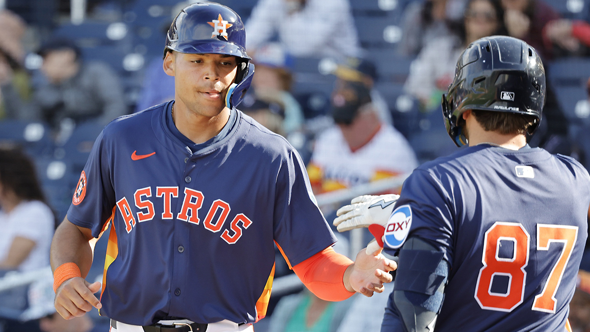 Houston Astros infielder Cam Smith (left) is congratulated by teammate Tommy Sacco Jr. (87) after scoring a run in the ninth inning against the Washington Nationals at CACTI Park of the Palm Beaches.