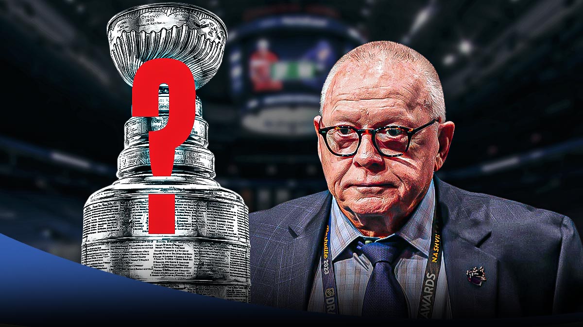 Canucks president Jim Rutherford inside Rogers Arena in Vancovuer, next to the Stanley Cup that has a giant question mark on it