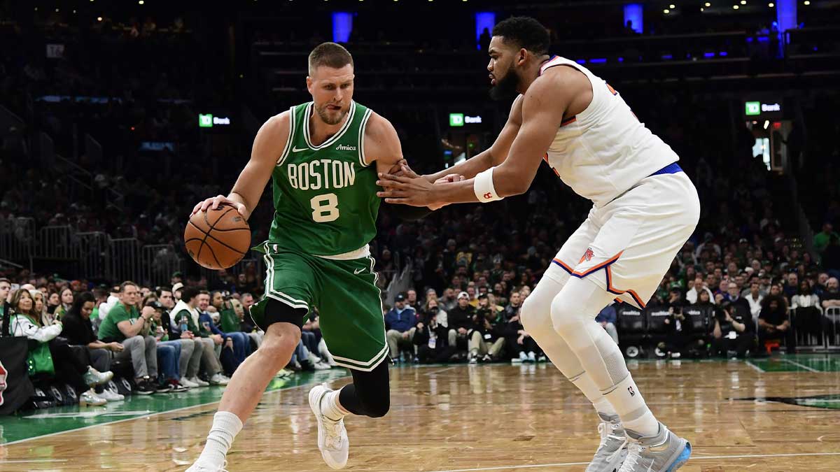 Celtics center Kristaps Porzingis (8) controls the ball while New York Knicks center Karl-Anthony Towns (32) defends during the second half at TD Garden