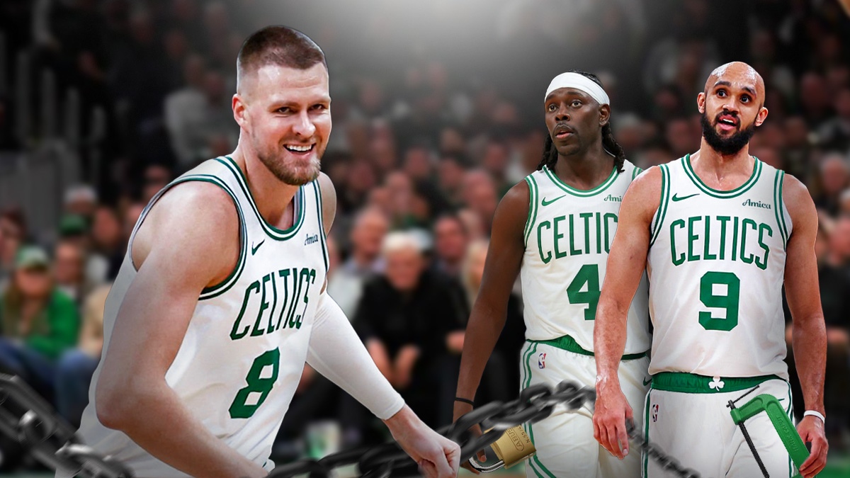 Celtics' Kristaps Porzingis looking at Derrick White and Jrue Holiday, who are holding chains, clamps, and padlocks