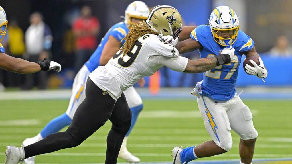 New Orleans Saints Defensive End Chsa Young (99) Stops Chargers Los Angeles Back JK Dobens (27) After a short rank in the second half at Sofia Stadium.