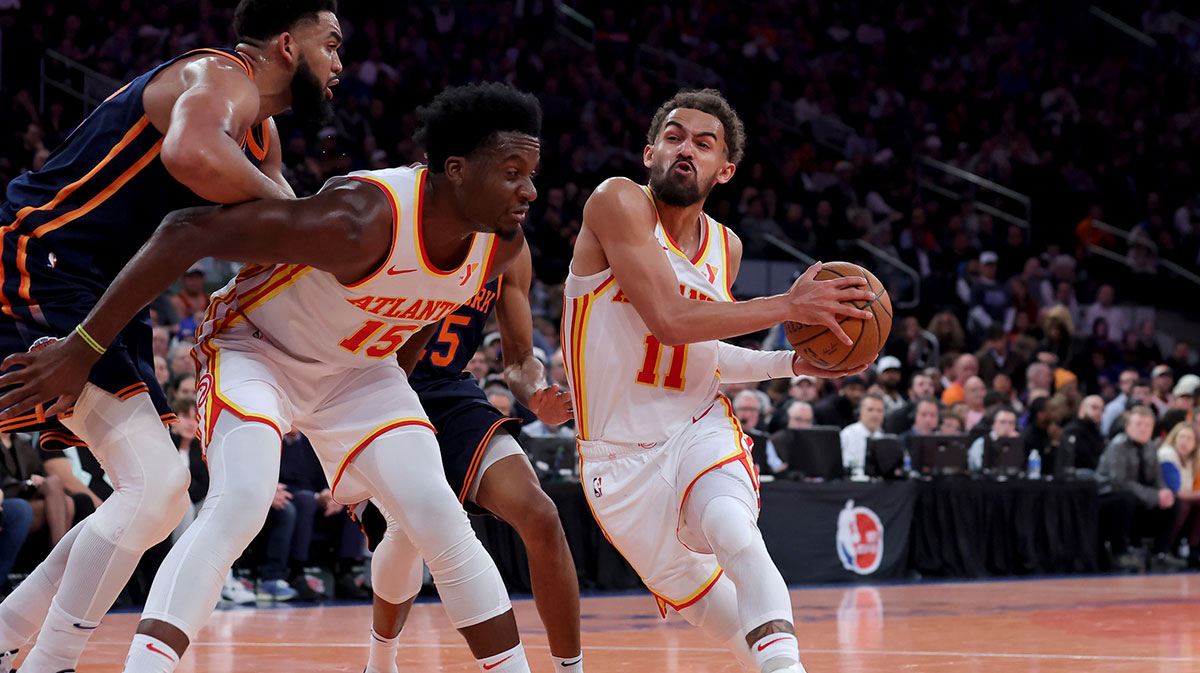 Atlanta Hawks guard Trae Young (11) drives to the basket against New York Knicks center Karl-Anthony Towns (32) and forward Mikal Bridges (25) as Hawks center Clint Capela (15) sets a pick during the second quarter at Madison Square Garden.