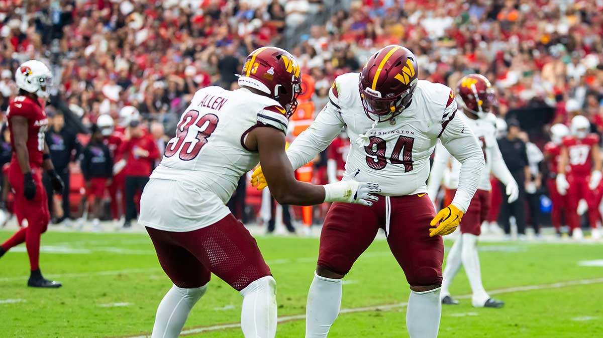 Washington Commanders defensive tackle Daron Payne (94) celebrates with teammate Jonathan Allen (93) after sacking Arizona Cardinals quarterback Kyler Murray (not pictured) in the second half at State Farm Stadium.