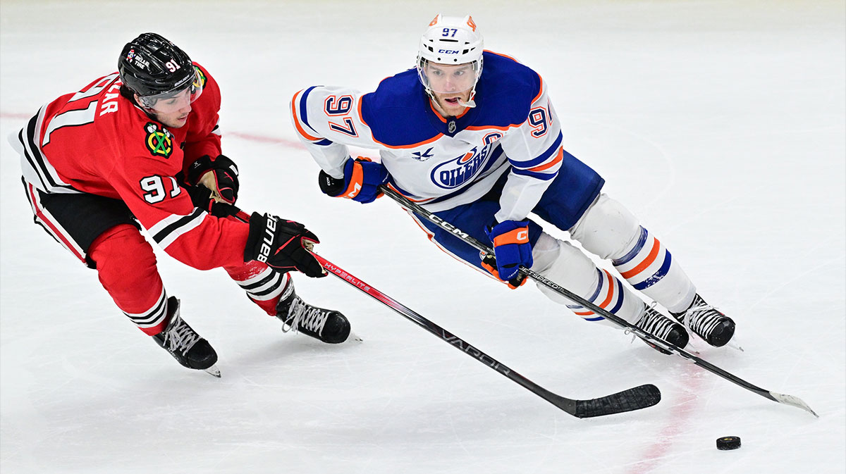 Edmonton Oilers center Connor McDavid (97) plays the puck as Chicago Blackhawks center Frank Nazar (91) defends during overtime at the United Center.