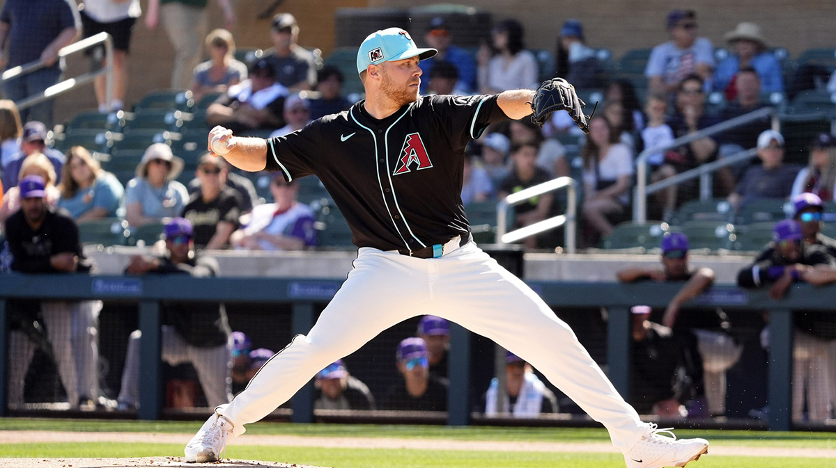 Arizona Diamondbacks pitcher Corbin Burnes throws to the Colorado Rockies in his debut on opening day of the spring training season