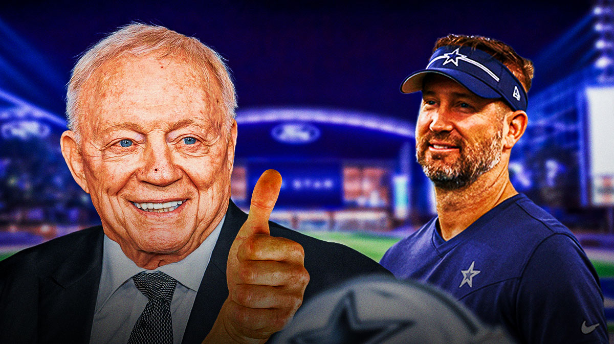 Cowboys owner Jerry Jones smiling and giving a thumbs up with Brian Schottenheimer next to him