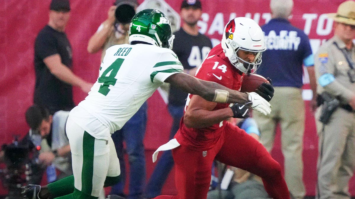 Arizona Cardinals wide receiver Michael Wilson (14) is tackled by New York Jets cornerback D.J. Reed (4) after a catch during the third quarter at State Farm Stadium in Glendale on Nov. 10, 2024.