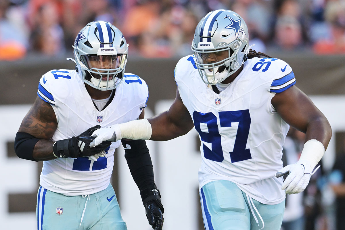 Dallas Cowboys linebacker Micah Parsons (11) celebrates with defensive tackle Osa Odighizuwa (97) after a sack during the first quarter against the Cleveland Browns at Huntington Bank Field.