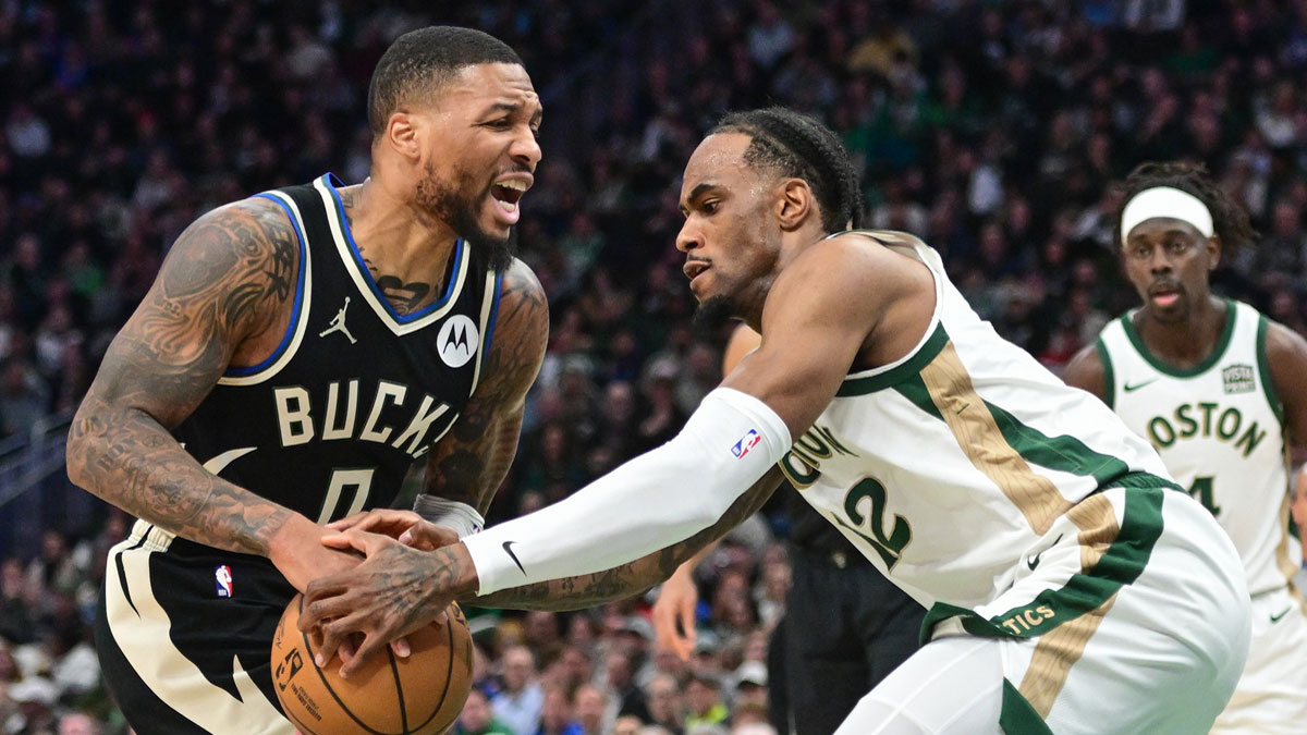 Milvaukee Bucks Guard Damian Lillard (0) Cart drives against Boston Celtics North Osha Brissett (12) in the second quarter of Fiserv Forum. 