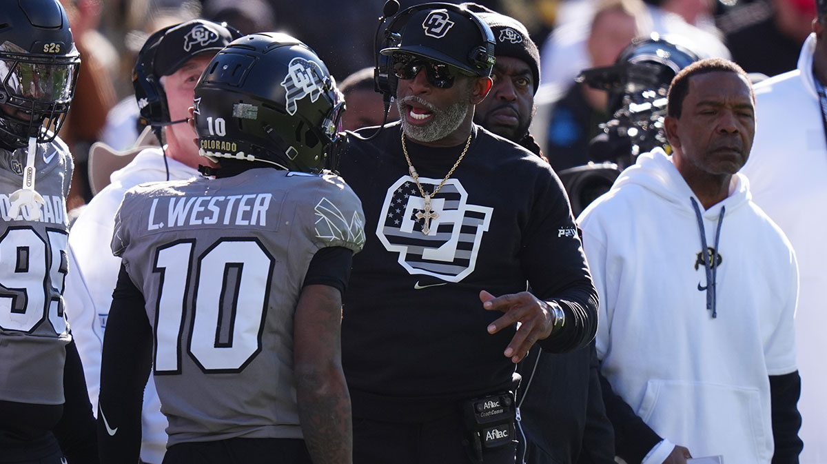 Colorado Buffaloes head coach Deion Sanders congratulates wide receiver LaJohntay Wester (10) for his punt return for a touchdown in the first quarter against the Utah Utes at Folsom Field.