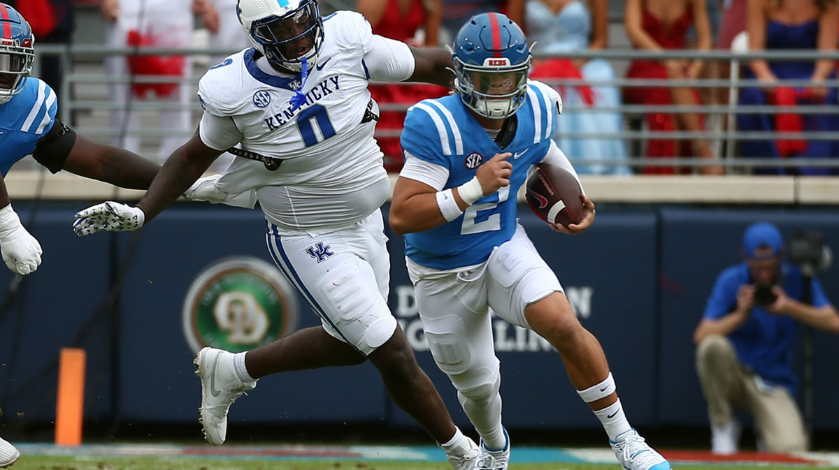 Mississippi Rebels quarterback Jaxson Dart (2) runs the ball as Kentucky Wildcats defensive linemen Deone Walker (0) pursues during the first half at Vaught-Hemingway Stadium.