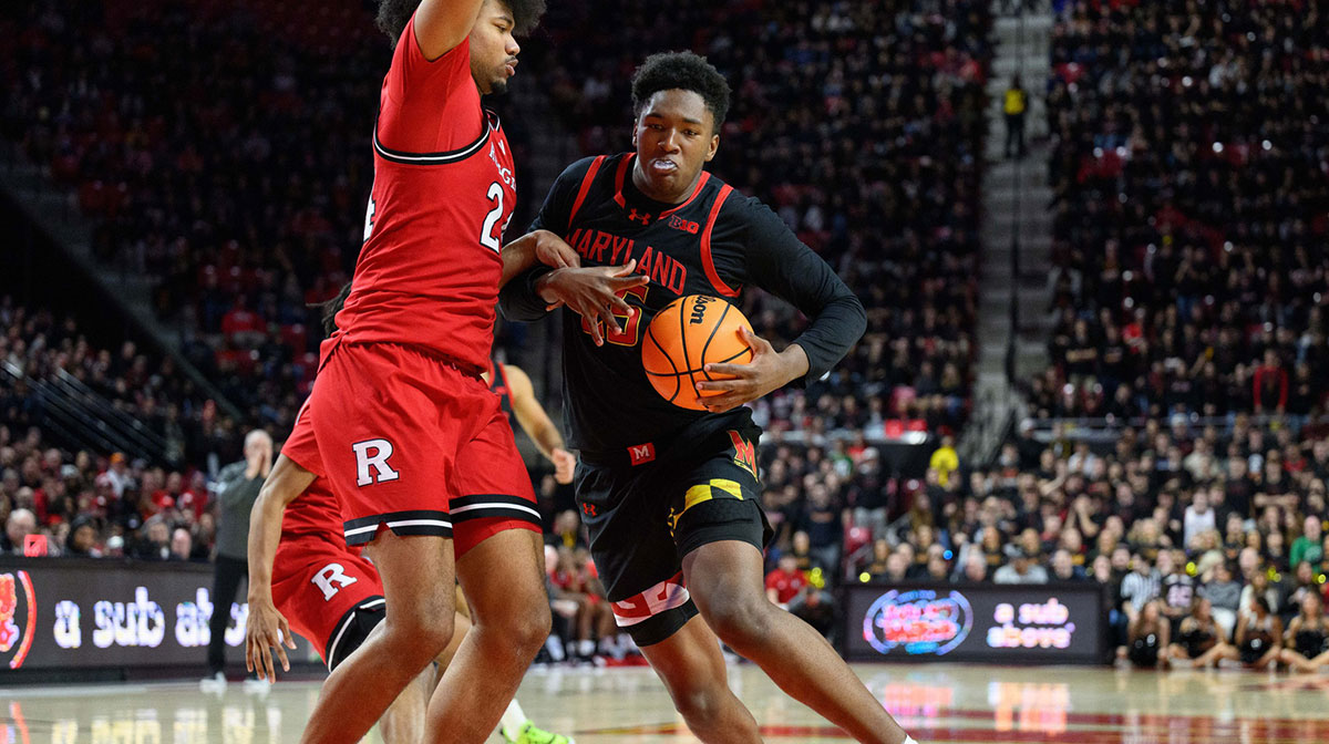 Feb 9, 2025; College Park, Maryland, USA; Maryland Terrapins center Derik Queen (25) handles the ball against Rutgers Scarlet Knights center Lathan Sommerville (24) during the second half at Xfinity Center. Mandatory Credit: Reggie Hildred-Imagn Images