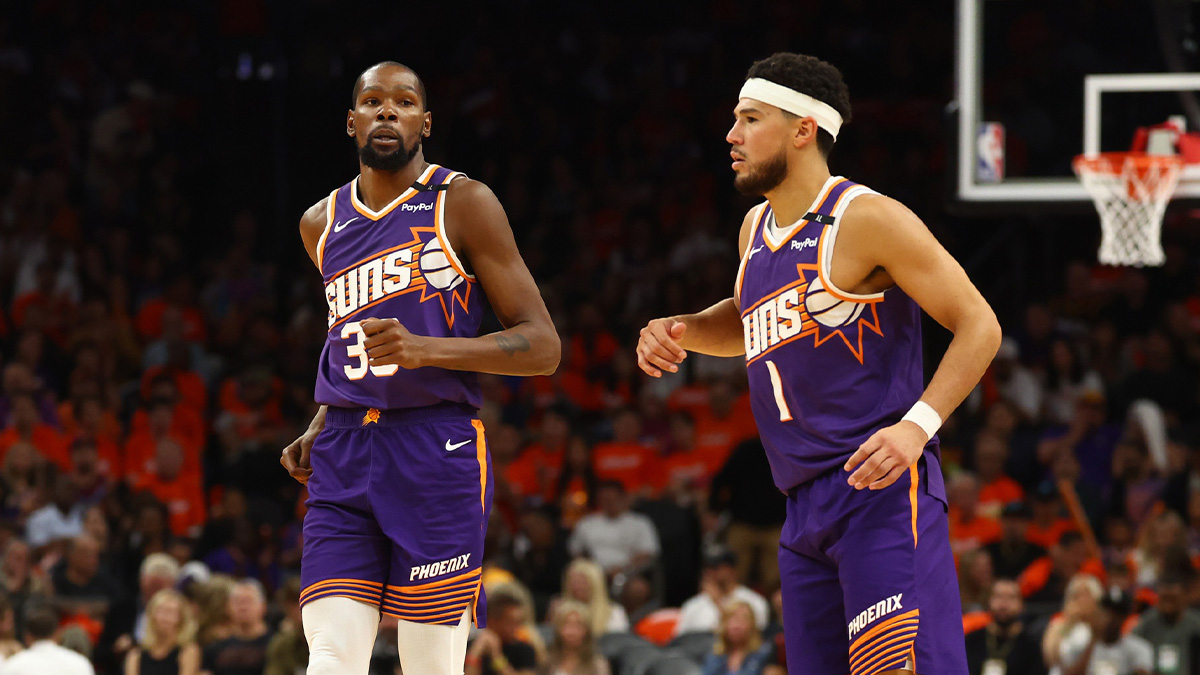 Phoenix Suns forward, Kevin Durant (35) and guarded Devin Booker (1) against Dallas Mavericks in a home opener at the footwear center.