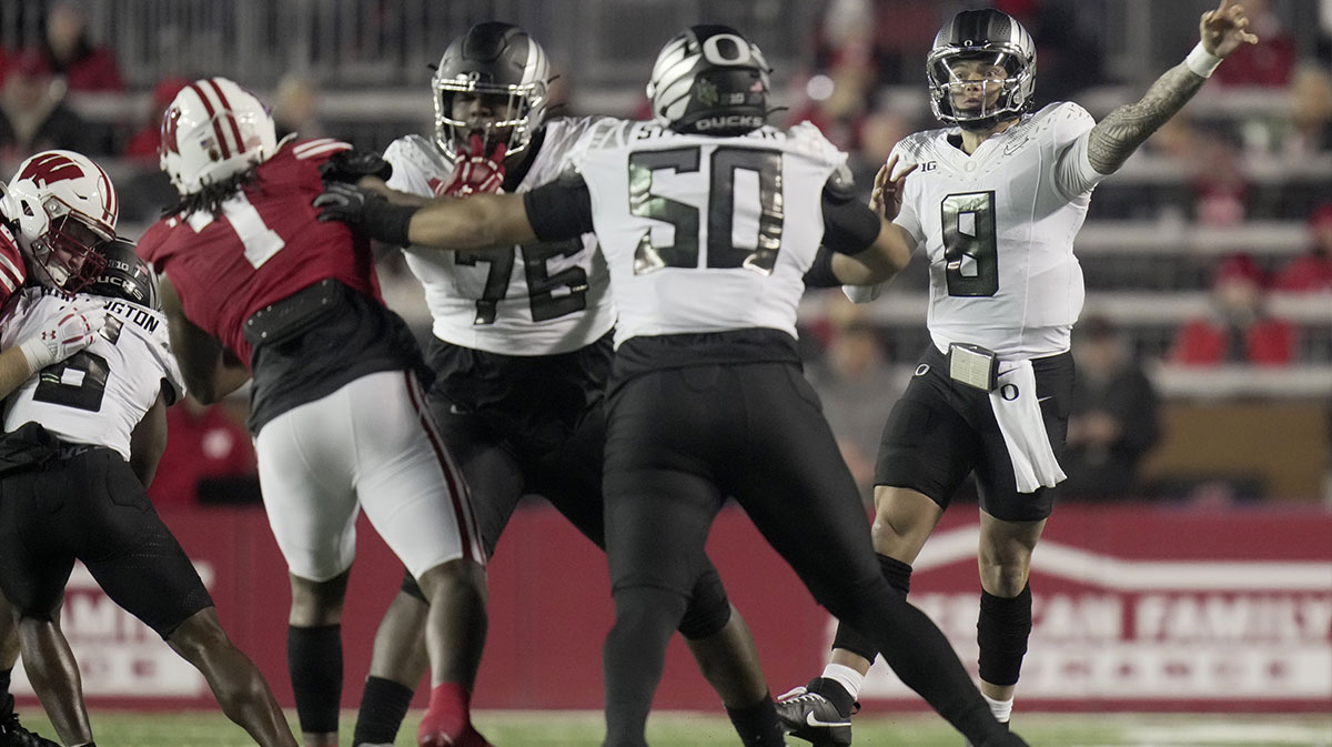 Oregon Ducks quarterback Dillon Gabriel (8) throws a pass during the first quarter at Camp Randall Stadium.